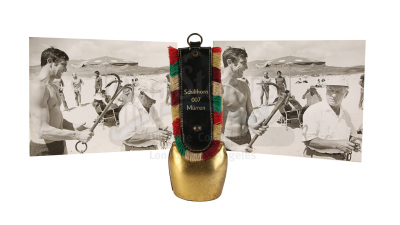 Lot #384 - JAMES BOND: ON HER MAJESTY'S SECRET SERVICE (1969) - Crew Gift Cowbell and Two Black-and-white On-set Photographs